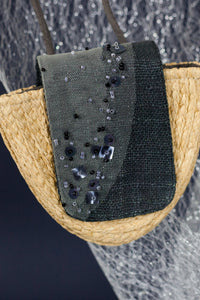 The combination of jewelry and wallet. The starry sky is depicted in decorative accents. The Thinking of Stars Neck Bag is made with natural Raffia, eco linen and some subtle touches to draw attention to the complexity. To complete a distinct contemporary look, wear it as a necklace, crossbody or even paired together as a bag.
