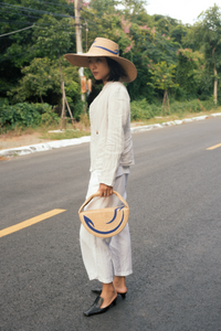 Cosmica raffia straw hat with flat crown and hand-sewn épuré fabric curves
